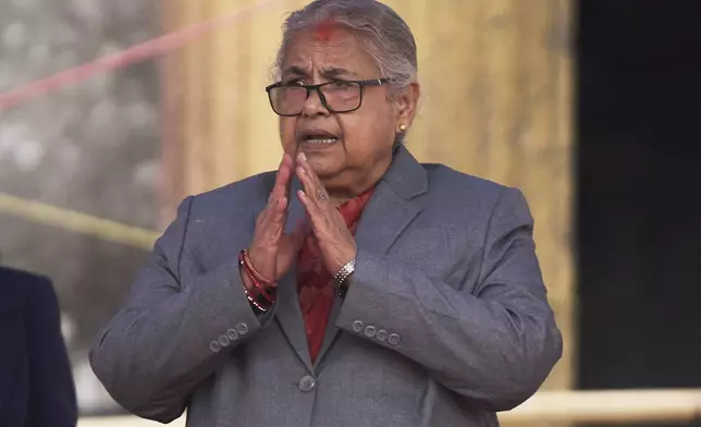 Nepal's new prime minister Sushila Karki greets ministers administered the oath of office by Nepalese President Ram Chandra Poudel at the presidential building in Kathmandu, Nepal, Monday, Sept. 15, 2025. (AP Photo/Niranjan Shrestha)