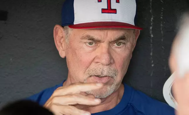 Texas Rangers manager Bruce Bochy speaks with reporters before the start of a baseball game against the Cleveland Guardians, Friday, Sept. 26, 2025, in Cleveland. (AP Photo/Phil Long)