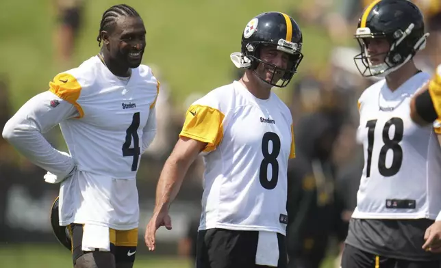FILE - Pittsburgh Steelers quarterback Aaron Rodgers (8) and wide receiver DK Metcalf (4) and quarterback Will Howard (18) participate in the NFL football team's training camp in Latrobe, Pa., Thursday, July 24, 2025. (AP Photo/Gene J. Puskar, File)
