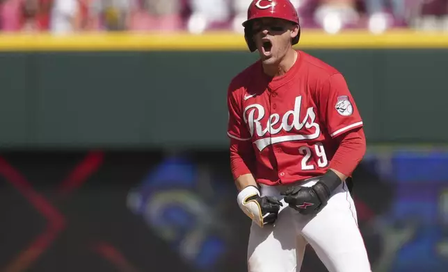 Cincinnati Reds' TJ Friedl reacts after hitting a one-run double in the ninth inning of a baseball game against the Toronto Blue Jays, Monday, Sept. 1, 2025, in Cincinnati. (AP Photo/Kareem Elgazzar)