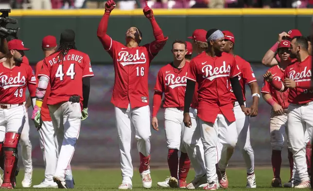 Cincinnati Reds' Noelvi Marte (16) celebrates with teammates after hitting a walkoff two-run single in the ninth inning of a baseball game against the Toronto Blue Jays, Monday, Sept. 1, 2025, in Cincinnati. (AP Photo/Kareem Elgazzar)