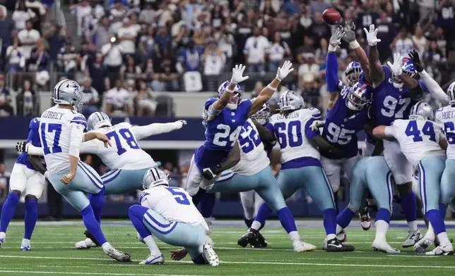 Dallas Cowboys place kicker Brandon Aubrey (17) kicks a game-winning field goal in overtime of an NFL football game against the New York Giants Sunday, Sept. 14, 2025, in Arlington, Texas. (AP Photo/Jeffrey McWhorter)