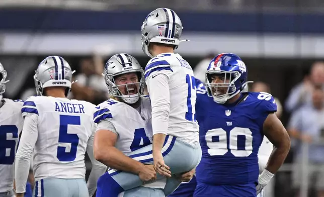 Dallas Cowboys' Trent Sieg (44 and Brandon Aubrey (17) celebrate after Aubrey kicked a game-winning field goal in overtime of an NFL football game against the New York Giants Sunday, Sept. 14, 2025, in Arlington, Texas. (AP Photo/Jerome Miron)