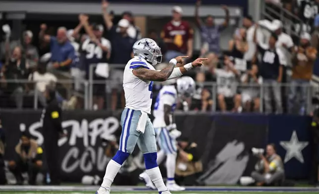 Dallas Cowboys quarterback Dak Prescott (4) celebrates a touchdown late in the second half of an NFL football game against the New York Giants Sunday, Sept. 14, 2025, in Arlington, Texas. (AP Photo/Jerome Miron)