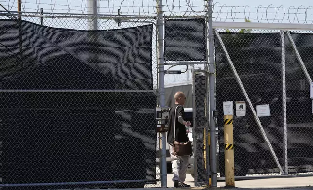 A person walks in to the entrance adjacent to an immigration processing center Monday, Sept. 8, 2025, in Broadview, Ill., a suburb of Chicago. (AP Photo/Carolyn Kaster)