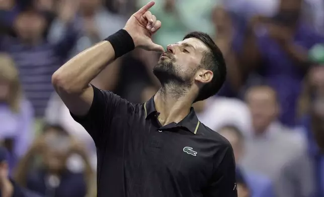 Novak Djokovic, of Serbia, reacts after defeating Taylor Fritz, of the United States, during the quarterfinal round of the U.S. Open tennis championships, Tuesday, Sept. 2, 2025, in New York. (AP Photo/Adam Hunger)