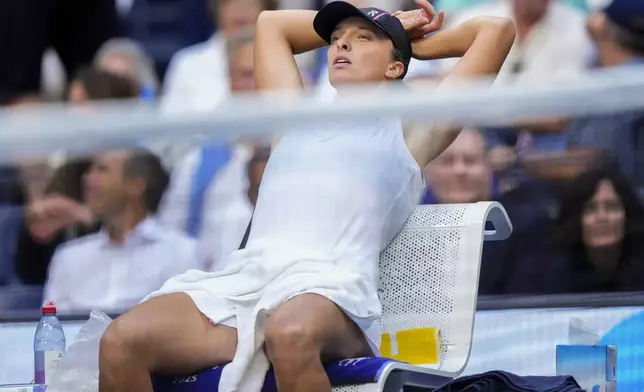 Iga Swiatek, of Poland, takes a break during a changeover in the second set against Amanda Anisimova, of the United States, during the quarterfinal round of the U.S. Open tennis championships, Wednesday, Sept. 3, 2025, in New York. (AP Photo/Yuki Iwamura)