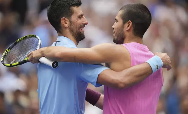 Novak Djokovic, of Serbia, congratulates Carlos Alcaraz, of Spain, after their the men's singles semifinals of the U.S. Open tennis championships, Friday, Sept. 5, 2025, in New York. (AP Photo/Seth Wenig)