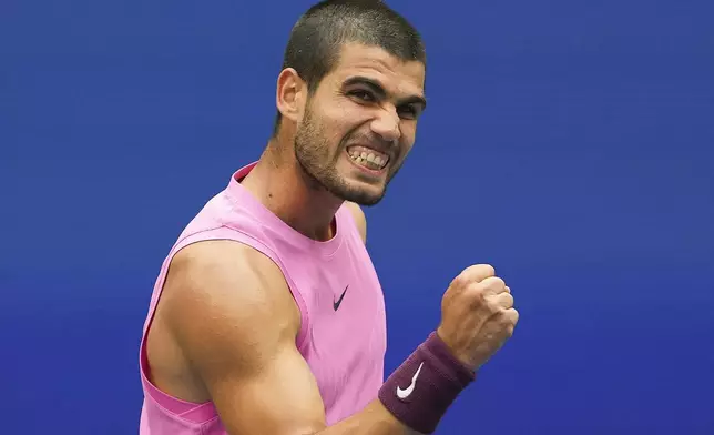 Carlos Alcaraz, of Spain, reacts after winning a game against Novak Djokovic, of Serbia, during the men's singles semifinals of the U.S. Open tennis championships, Friday, Sept. 5, 2025, in New York. (AP Photo/Kirsty Wigglesworth)
