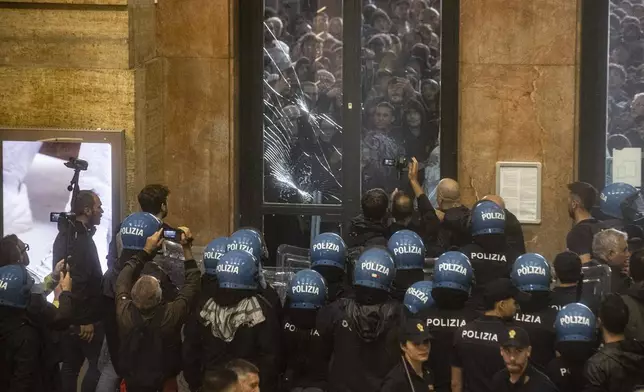 Protesters enter Central Station during clashes with police after the strike march in support of Palestine, in Milan, Italy, Monday, Sept. 22, 2025. (Marco Ottico/Lapresse via AP)