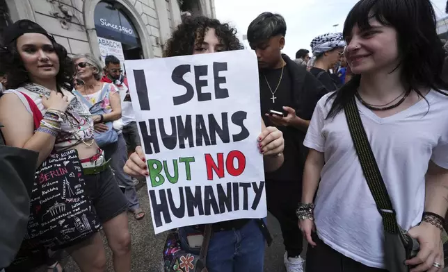 People hold banners as they participate at a demonstration part of a nation-wide protest and general strike against the war in Gaza, in Rome, Monday, Sept. 22, 2025. (AP Photo/Alessandra Tarantino)