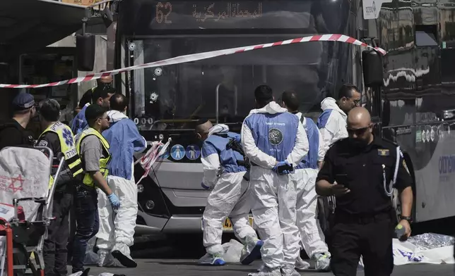 Israeli police and rescue teams respond at the scene of a shooting attack where several people killed and injured in Jerusalem, Monday, Sept. 8, 2025. (AP Photo/Mahmoud Illean)