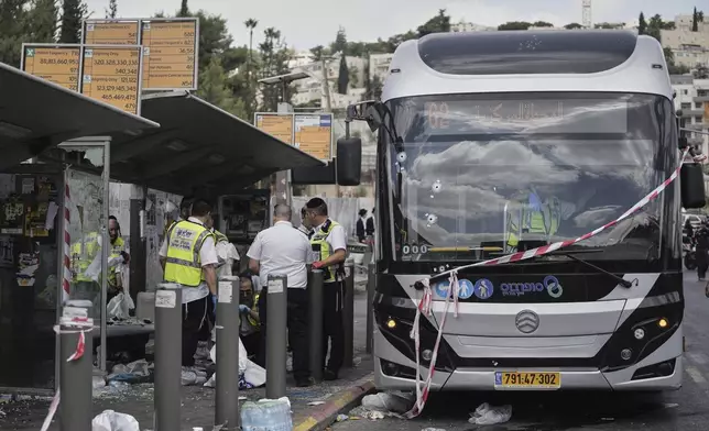 Israeli police and rescue teams inspect the scene of a shooting attack where several people killed and injured at a bus stop in Jerusalem, Monday, Sept. 8, 2025. (AP Photo/Mahmoud Illean)