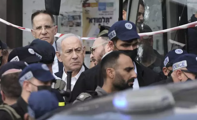 Israeli Prime Minister Benjamin Netanyahu visits the site of a shooting attack where several people killed and injured at a bus stop in Jerusalem, Monday, Sept. 8, 2025. (AP Photo/Mahmoud Illean)