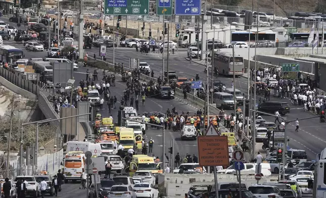 Israeli police and rescue teams respond at the scene of a shooting attack where several people killed and injured in Jerusalem, Monday, Sept. 8, 2025. (AP Photo/Mahmoud Illean)