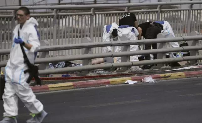 Israeli police and rescue teams respond at the scene of a shooting attack where several people killed and injured in Jerusalem, Monday, Sept. 8, 2025. (AP Photo/Mahmoud Illean)