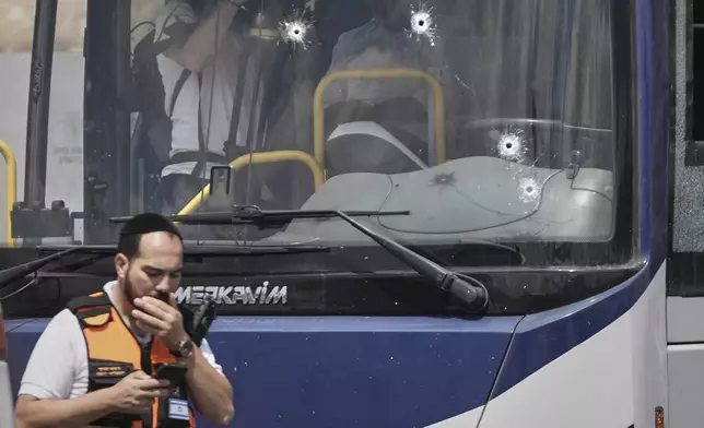 Israeli police and rescue teams inspect the scene of a shooting attack where several people killed and injured in Jerusalem, Monday, Sept. 8, 2025. (AP Photo/Mahmoud Illean)