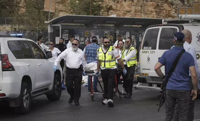 Israeli Zaka rescue and recovery team carry the body of a victim at the scene of shooting attack where several people killed and injured in Jerusalem, Monday, Sept. 8, 2025. (AP Photo/Mahmoud Illean)