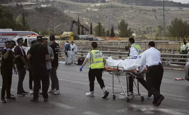 Israeli Zaka rescue and recovery team carry the body of a victim at the scene of shooting attack where several people killed and injured in Jerusalem, Monday, Sept. 8, 2025. (AP Photo/Mahmoud Illean)