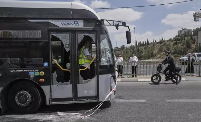 Israeli police and rescue teams inspect the scene of a shooting attack carried out by two Palestinian gunmen, in which several people were killed and others injured at a bus stop in Jerusalem, Monday, Sept. 8, 2025. (AP Photo/Mahmoud Illean)