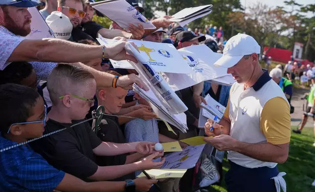 Europe's Rory McIlroy, of Northern Ireland, signs during a practice round for the Ryder Cup golf tournament, Tuesday, Sept. 23, 2025, in Farmingdale, N.Y., at Bethpage State Park's Black Course. (AP Photo/Matt Slocum)