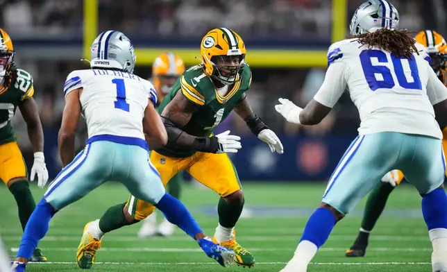 Green Bay Packers defensive end Micah Parsons (1) rushes as Dallas Cowboys' Jalen Tolbert (1) and Tyler Guyton (60) defend in the first half of an NFL football game Sunday, Sept. 28, 2025, in Arlington, Texas. (AP Photo/Julio Cortez)