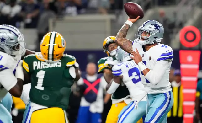 Dallas Cowboys quarterback Dak Prescott (4) throws a pass under pressure from Green Bay Packers defensive end Micah Parsons (1) in the first half of an NFL football game Sunday, Sept. 28, 2025, in Arlington, Texas. (AP Photo/Jeffrey McWhorter)