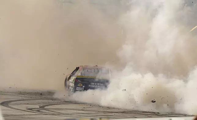 Chase Briscoe does a burnout after winning a NASCAR Cup Series auto race at Darlington Raceway, Sunday, Aug. 31, 2025, in Darlington, S.C. (AP Photo/Matt Kelley)