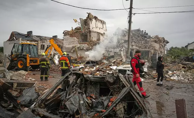 Rescuers work at the site of an apartment buildings damaged during a Russian attack in Kyiv, Ukraine, Sunday, Sept. 28, 2025. (AP Photo/Efrem Lukatsky)