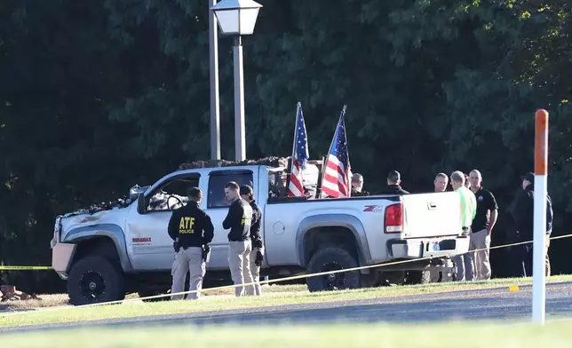 ATF police stand by the vehicle used to ram the exterior of the Church of Jesus Christ of Latter-day Saints, Monday, Sept. 29, 2025 in Grand Blanc Township, Mich. (AP Photo/Carlos Osorio)