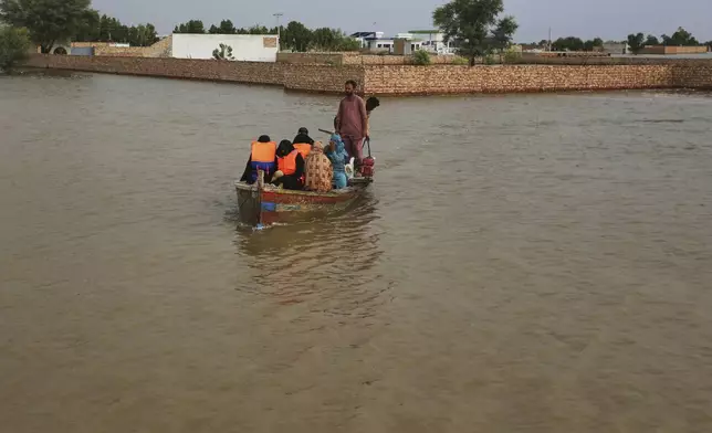 Rescue workers evacuate villagers from a flooded area following raising water level in rivers, in Jalalpur Pirwala, in Multan district, Pakistan, Monday, Sept. 8, 2025. (AP Photo/Asim Tanveer)
