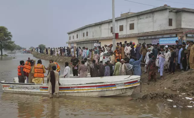 Villagers get off from a boat after being evacuated by rescue workers from a flooded area following raising water level in rivers, in Jalalpur Pirwala, in Multan district, Pakistan, Monday, Sept. 8, 2025. (AP Photo/Asim Tanveer)