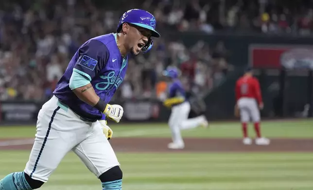 Arizona Diamondbacks' Ildemaro Vargas shouts in celebration after hitting a three-run home run against the Boston Red Sox during the third inning of a baseball game Friday, Sept. 5, 2025, in Phoenix. (AP Photo/Ross D. Franklin)