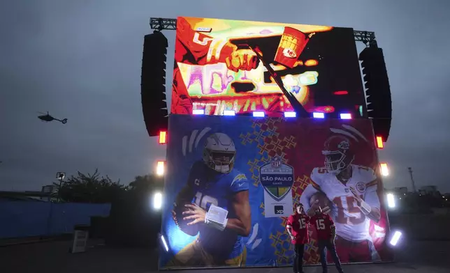 Fans arrives for an NFL football game between the Kansas City Chiefs and the Los Angeles Chargers, Friday, Sept. 5, 2025, in Sao Paulo. (AP Photo/Andre Penner)