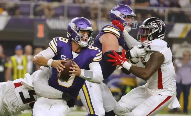 Atlanta Falcons defensive tackle Brandon Dorlus (54) sacks Minnesota Vikings quarterback J.J. McCarthy (9) during the first half of an NFL football game, Sunday, Sept. 14, 2025, in Minneapolis. (AP Photo/Bruce Kluckhohn)