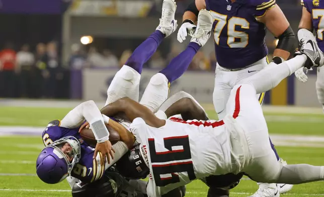 Atlanta Falcons defensive end Zach Harrison (96) sacks Minnesota Vikings quarterback J.J. McCarthy (9) during the first half of an NFL football game, Sunday, Sept. 14, 2025, in Minneapolis. (AP Photo/Bruce Kluckhohn)