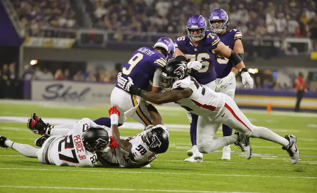Atlanta Falcons defensive end Zach Harrison (96) sacks Minnesota Vikings quarterback J.J. McCarthy (9) during the first half of an NFL football game, Sunday, Sept. 14, 2025, in Minneapolis. (AP Photo/Bruce Kluckhohn)