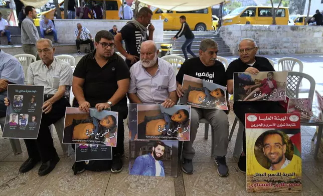 Palestinian activists carry posters that read "no for the starvation of Gaza," during a hunger strike sit-in in the West Bank city of Ramallah, Tuesday, Sept. 16, 2025. (AP Photo/Nasser Nasser)