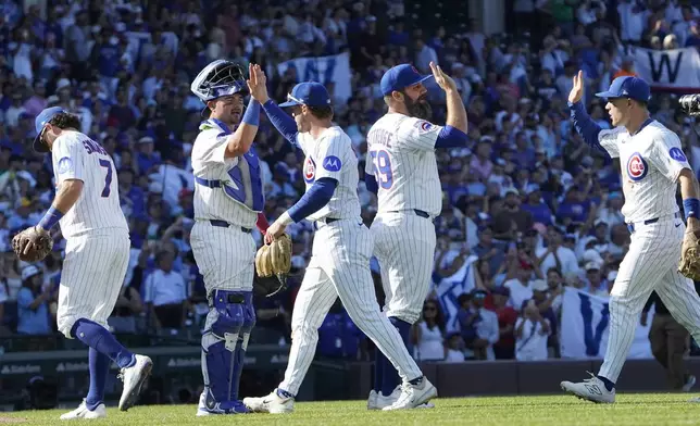 The Chicago Cubs celebrate their win against the Tampa Bay Rays in a baseball game Sunday, Sept. 14, 2025, in Chicago. (AP Photo/David Banks)
