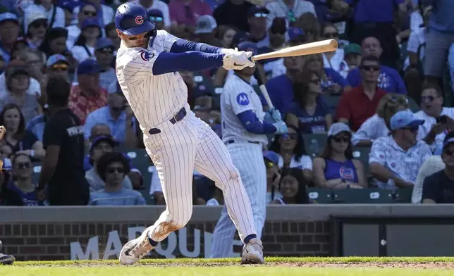 Chicago Cubs' Nico Hoerner hits a two-run double against the Tampa Bay Rays during the seventh inning of a baseball game Sunday, Sept. 14, 2025, in Chicago. (AP Photo/David Banks)