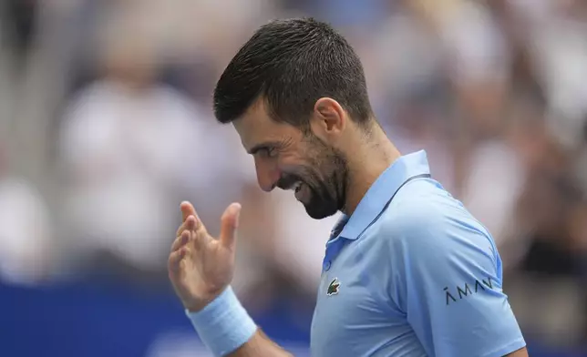 Novak Djokovic, of Serbia, reacts afer winnning a point against Carlos Alcaraz, of Spain, during the men's singles semifinals of the U.S. Open tennis championships, Friday, Sept. 5, 2025, in New York. (AP Photo/Seth Wenig)