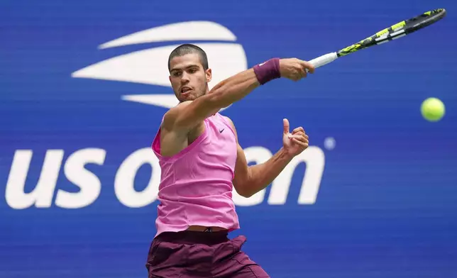 Carlos Alcaraz, of Spain, returns a shot to Jiri Lehecka, of the Czech Republic, during the quarterfinal round of the U.S. Open tennis championships, Tuesday, Sept. 2, 2025, in New York. (AP Photo/Kirsty Wigglesworth)
