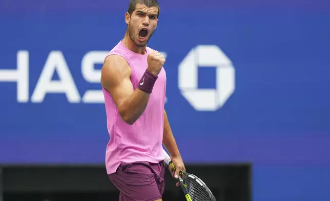 Carlos Alcaraz, of Spain, reacts after winning the second set against Novak Djokovic, of Serbia, during the men's singles semifinals of the U.S. Open tennis championships, Friday, Sept. 5, 2025, in New York. (AP Photo/Kirsty Wigglesworth)