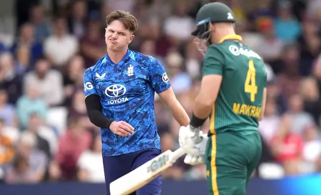 England's Sonny Baker, left, reacts after South Africa's Aiden Markram, right, reaches 50 runs for a half century during the One Day International Series cricket match between England and South Africa at Headingley, Leeds, England, Tuesday, Sept. 2, 2025. (Danny Lawson/PA via AP)