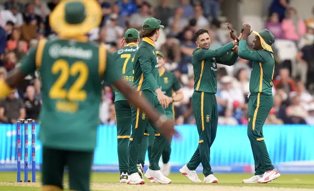 South Africa's players celebrate the wicket of England's Sonny Baker during the One Day International Series cricket match between England and South Africa at Headingley, Leeds, England, Tuesday, Sept. 2, 2025. (Danny Lawson/PA via AP)