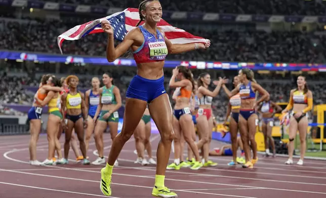 United States' Anna Hall celebrates after wining the gold in the heptathlon at the World Athletics Championships in Tokyo, Saturday, Sept. 20, 2025. (AP Photo/Petr David Josek)