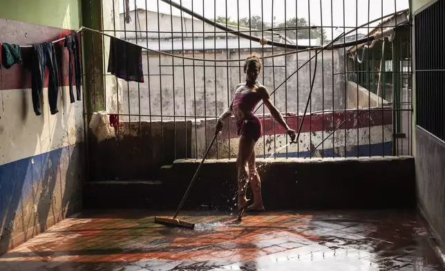 FILE PHOTO GALLERY - Magali Vargas strikes a pose while cleaning the floor of the pavilion reserved for transgender inmates at the Regional Penitentiary in Coronel Oviedo, Paraguay, Aug. 30, 2024. (AP Photo/Rodrigo Abd)