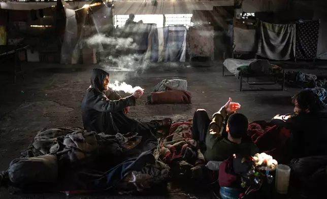 FILE PHOTO GALLERY - Inmates smoking crack, who are referred to as "Cambodians", are housed in one of the poorest sections of the Tacumbu prison known as the pavilion, in Asuncion, Paraguay, July 8, 2024. (AP Photo/Rodrigo Abd)