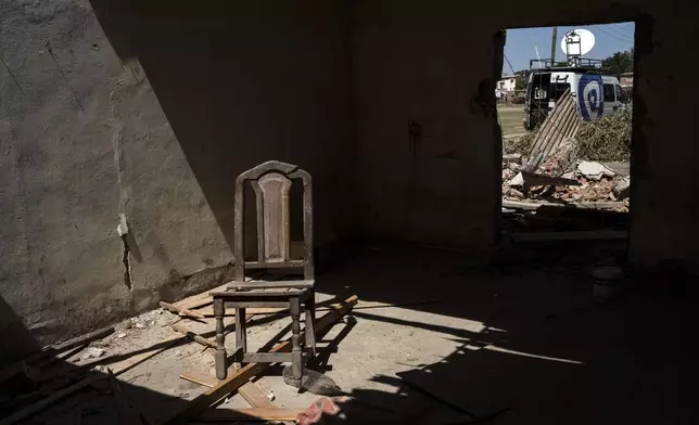 FILE PHOTO GALLERY - A chair sits inside inside a house that residents say is an alleged drugs sales point known as the “Bunker” which was destroyed by neighbors and relatives of an 11-year-old boy who was fatally shot when at least one gunmen attacked a birthday party in Los Pumitas neighborhood of Rosario, Argentina, March 7, 2023. (AP Photo/Rodrigo Abd)