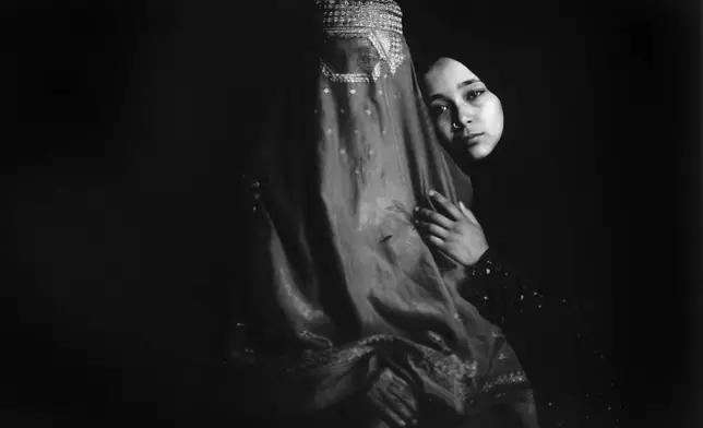 FILE PHOTO GALLERY - Hakimeh, 55, and her daughter Fereshte, 17, pose for a portrait in a carpet factory where they work in Kabul, Afghanistan, May 29, 2023. (AP Photo/Rodrigo Abd, File)